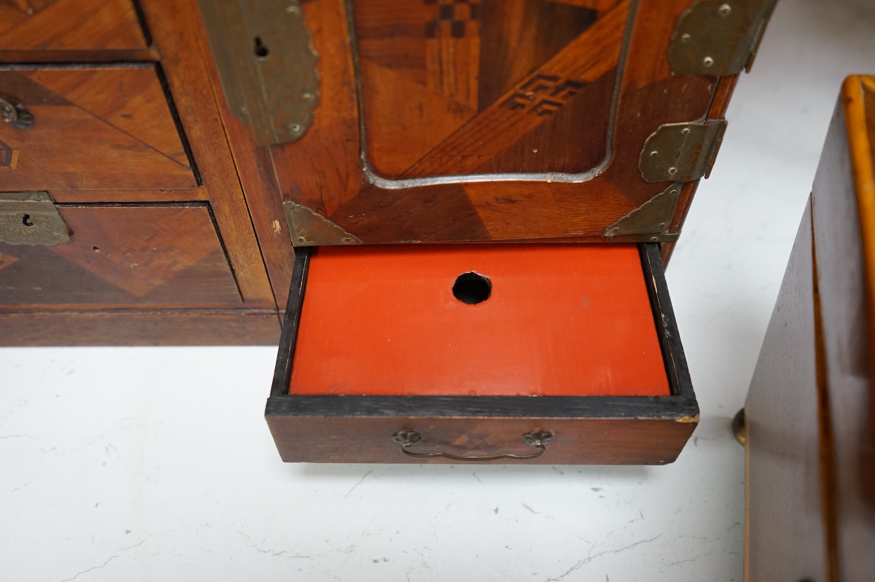 A Japanese parquetry table-top cabinet and a 19th century tea caddy, cabinet 33cm wide, 26cm high.